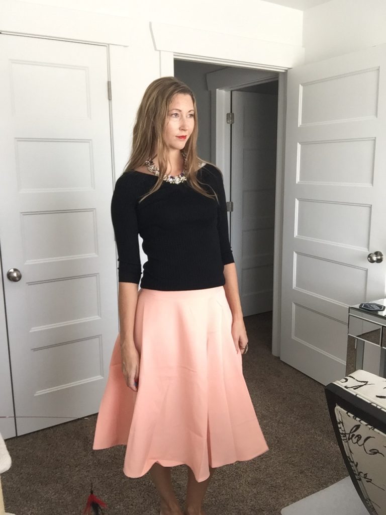 black 3/4 sleeve sweater and peach skirt 