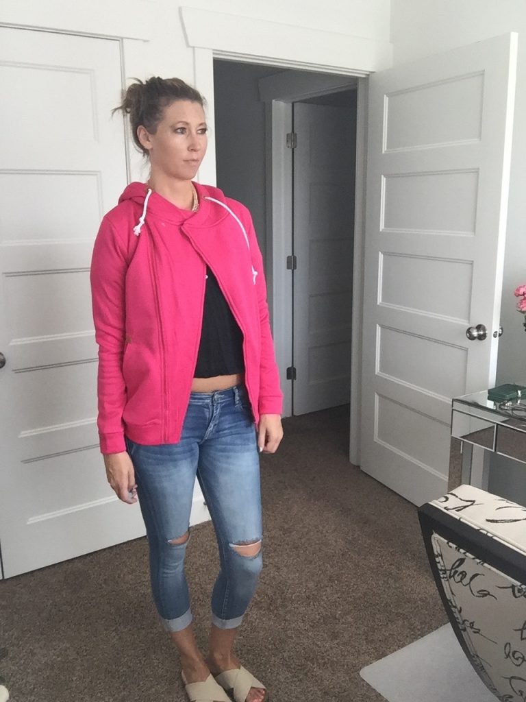 pink hoodie, denim jeans, and sandals