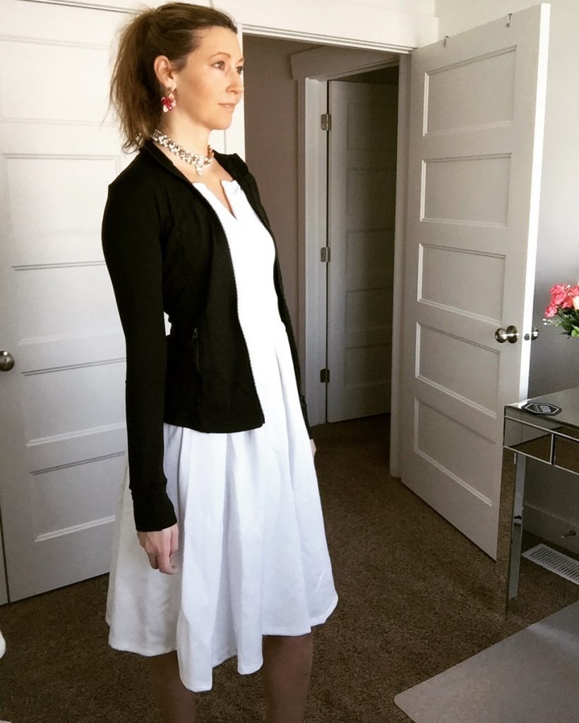 black fitness jacket and white a line dress