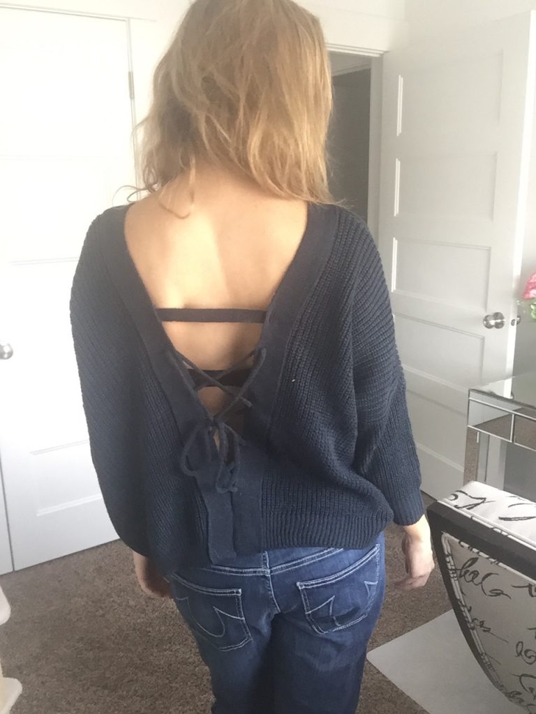 open back black sweater and denim