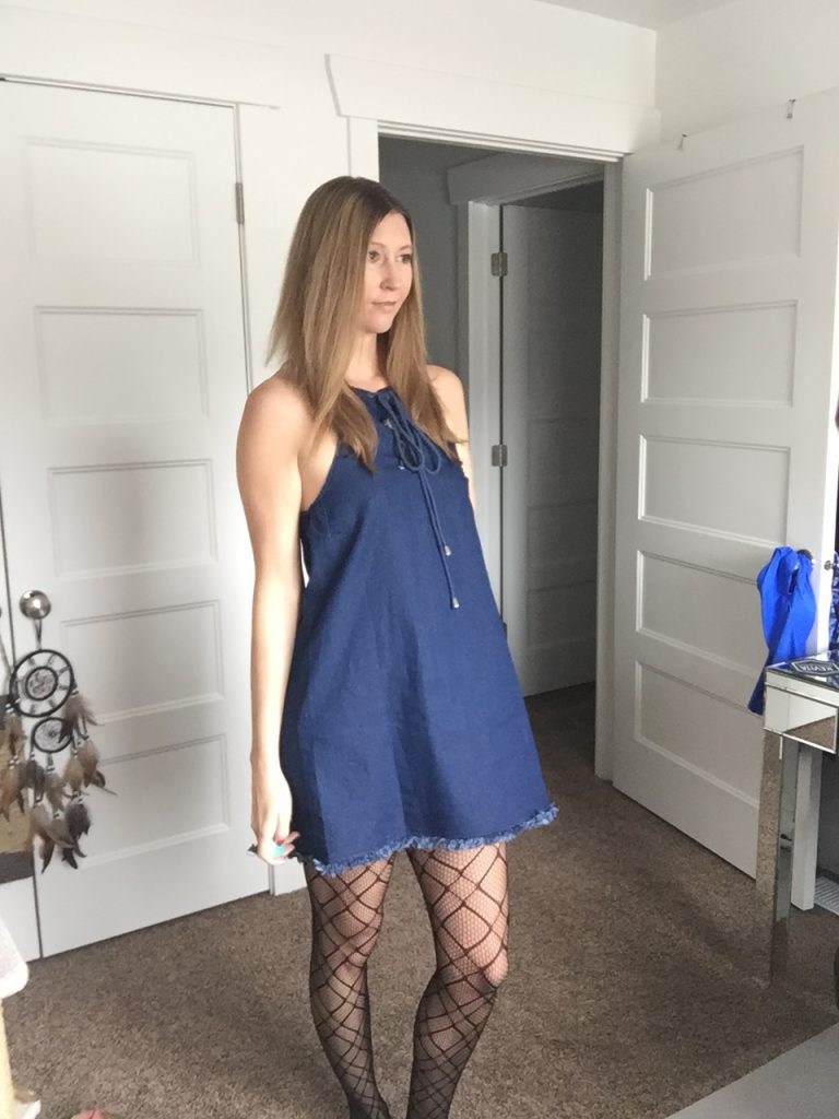 woman in Denim halter Dress and Printed Fishnet Tights