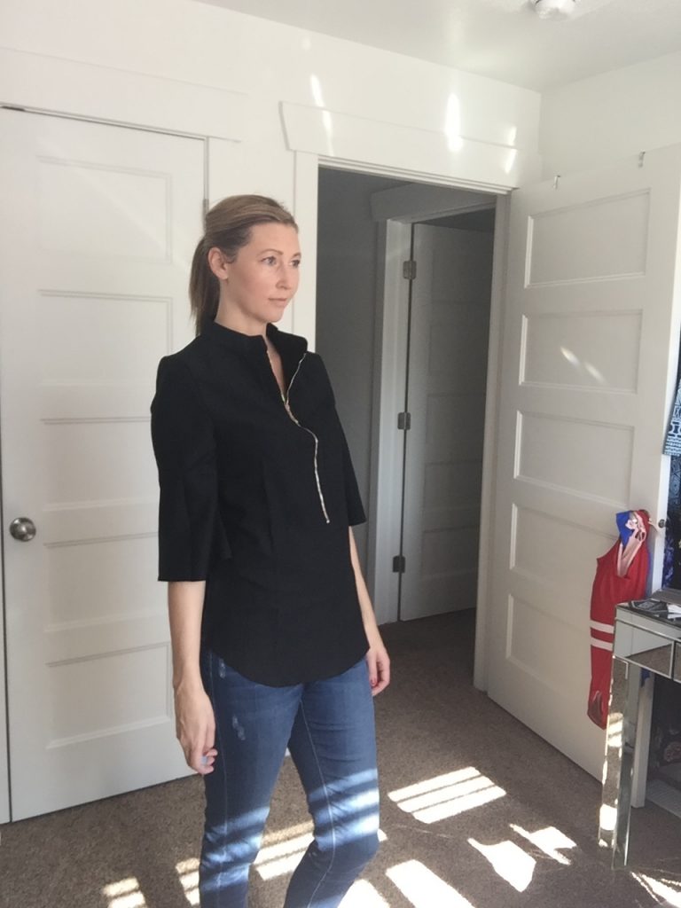 Woman in Black 3/4 Sleeve Zip Front Blouse and jeans