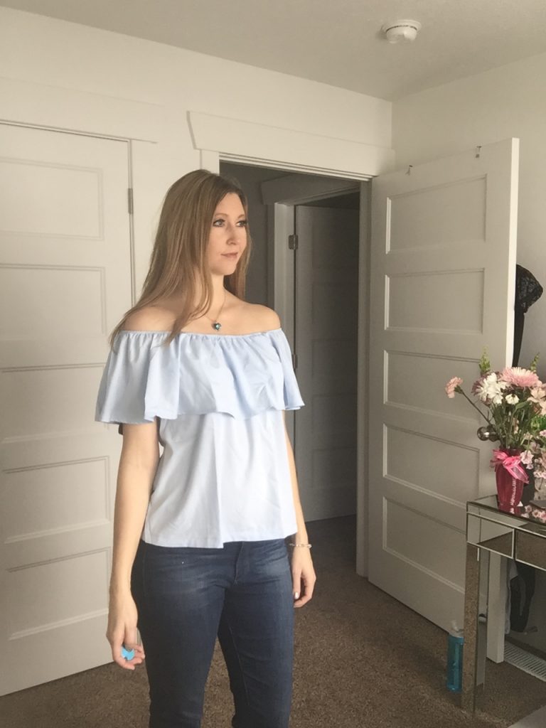 Woman in blue ruffle top and jeans