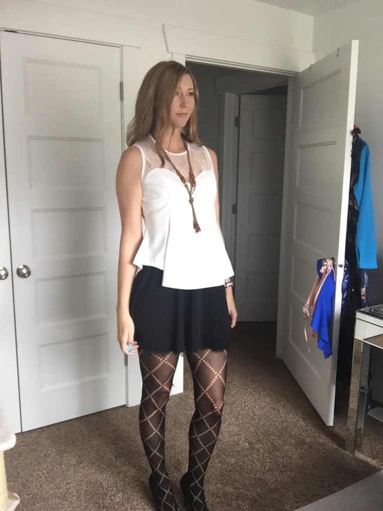 woman in White Mesh Bustier Top, Black Skirt and Print Tights